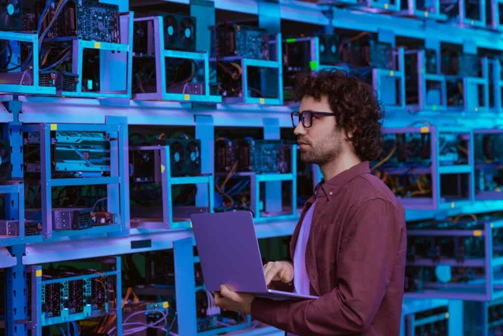 man standing next to database