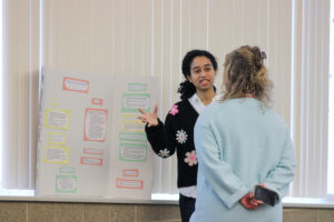 Counseling student presenting research board
