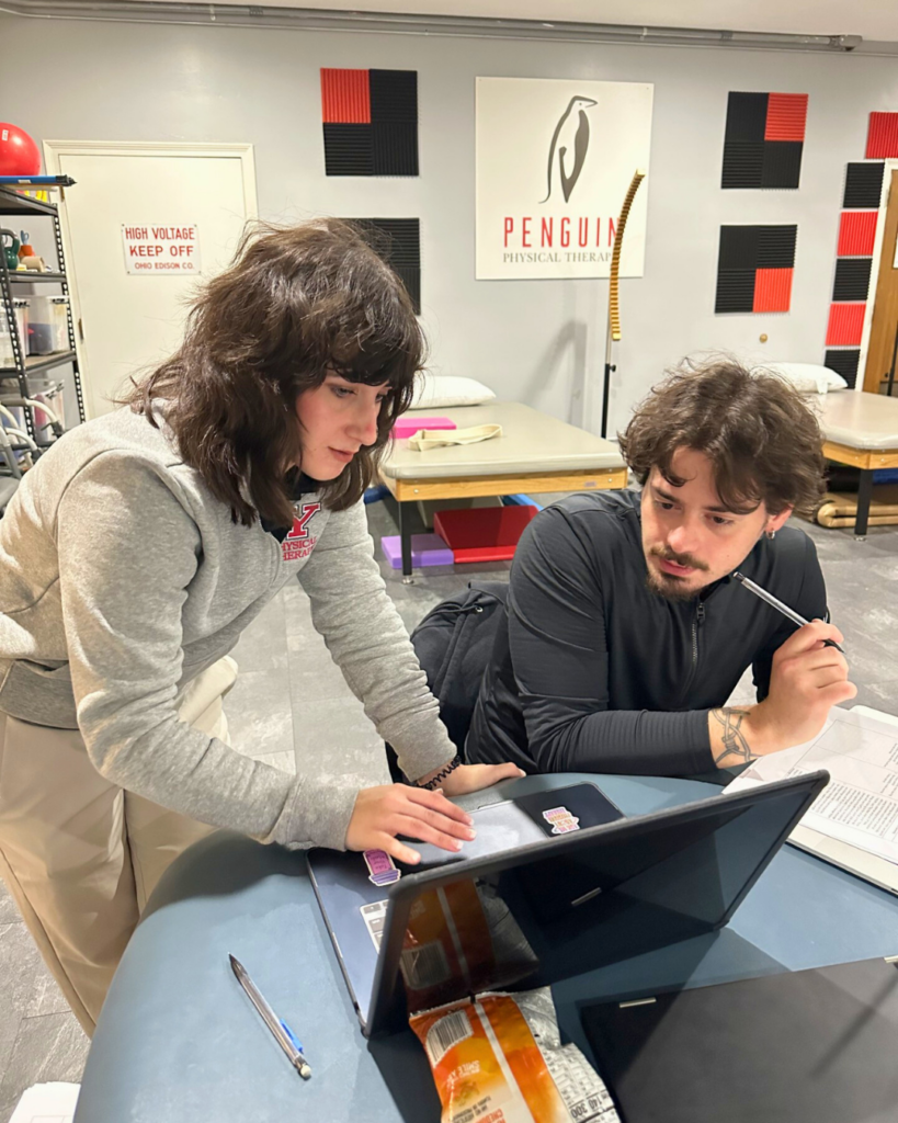 Two Doctor of Physical Therapy students collaborate while reviewing patient information in the Penguin Physical Therapy Clinic.
