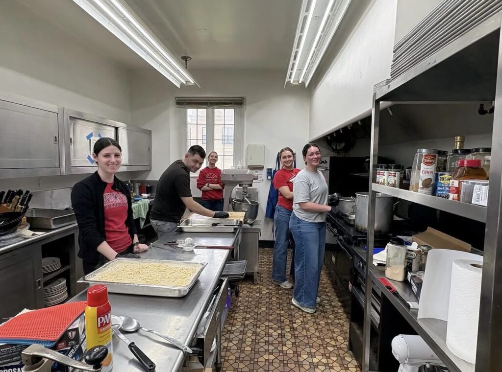 YSU Students in Dietetics prepare meals while volunteering at the Red Door Café at Saint John's Church.