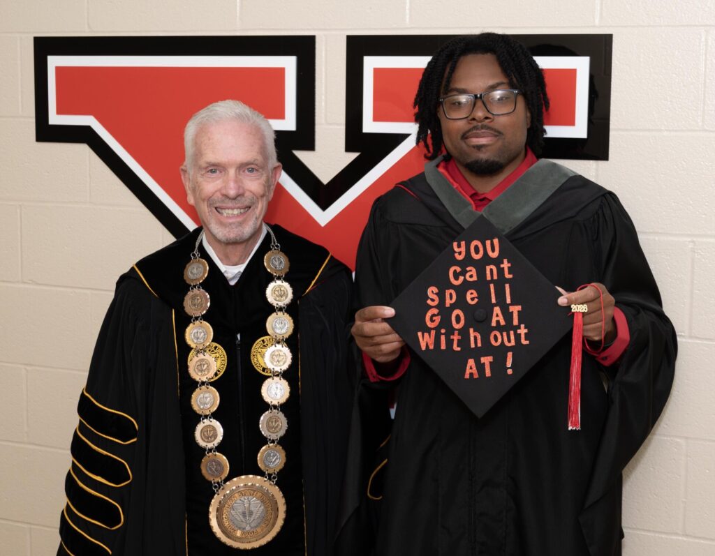 Terrance Harris poses with Youngstown State University President Bill Johnson after graduating from YSU's Master of Athletic Training program.