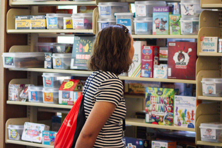 YSU teacher Education student browsing board games in the CRC.